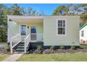Renovated light green house with a porch and landscaping at 2268 Bailey Dr, North Charleston, SC 29405