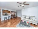 Living room with hardwood floors, a sofa, and built-in shelving at 2311 Tall Sail Dr # B, Charleston, SC 29414