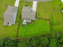 Aerial view showing house, fenced backyard, and neighboring houses at 4041 Oxeye Loop, Johns Island, SC 29455