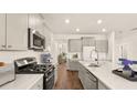 Modern kitchen with gray cabinets, quartz countertops, and stainless steel appliances at 569 Richfield Way, Summerville, SC 29486