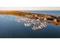 Aerial view of waterfront homes and a marina with many boats at 67 W We 10Th St # A-8, Folly Beach, SC 29439