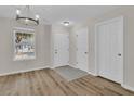 Light and bright entryway with wood-look floors and chandelier at 7936 Vermont Rd, North Charleston, SC 29418