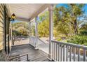 Charming front porch with white railings and wooden floors at 882 Sedge Ct, Charleston, SC 29412