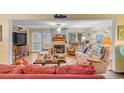 Spacious living area with hardwood floors, fireplace and ample natural light at 10 Chapman Ave, Isle of Palms, SC 29451