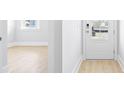 Light and bright entryway with luxury vinyl plank flooring and white doors at 116 Lilac Grove Way, Summerville, SC 29486