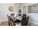 Dining room with dark wood table, six chairs, and decorative wall art at 132 Lilac Grove Way, Summerville, SC 29486