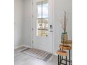 Bright entryway with a white door, wood-look floors and simple decor at 132 Lilac Grove Way, Summerville, SC 29486
