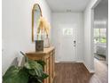 Bright and airy foyer with wood-look floors and stylish decor at 136 Lilac Grove Way, Summerville, SC 29486