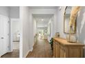 Long hallway with wood-look floors offering views into the living room at 136 Lilac Grove Way, Summerville, SC 29486