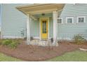 Inviting yellow front door entrance with a covered porch at 1455 Red Tide Rd, Mount Pleasant, SC 29466