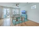 Bright living room with hardwood floors, a ceiling fan, and access to a patio at 1455 Red Tide Rd, Mount Pleasant, SC 29466