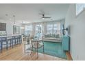 Open living area with hardwood floors, comfy sofas, and a view to the kitchen at 1455 Red Tide Rd, Mount Pleasant, SC 29466