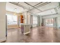 Open concept living room and kitchen with exposed ductwork and concrete floors at 150 Bee St # 318, Charleston, SC 29401