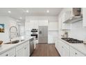 White kitchen with stainless steel appliances and large island at 206 Denham St, Summerville, SC 29486