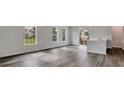 Spacious living room with gray vinyl plank flooring and sliding glass doors at 209 Terrace View Dr, Summerville, SC 29486
