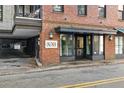 Building entrance with brick facade and modern glass doors at 21 George St # 114, Charleston, SC 29401