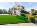Bright yellow house with palm trees and manicured lawn at 217 Old Hickory Xing, Johns Island, SC 29455