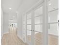 Bright and airy entryway with hardwood floors and French doors leading to an office at 349 Trailmore Ln, Summerville, SC 29486