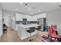 Open concept kitchen with white cabinets, quartz countertops, and island seating at 396 Painted Lady Ln, Goose Creek, SC 29445