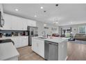 Modern white kitchen with stainless steel appliances and an island at 396 Painted Lady Ln, Goose Creek, SC 29445