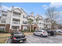 Three-story building with brick and siding, balconies, and parking spaces at 45 Sycamore Ave # 523, Charleston, SC 29407