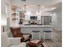 Modern kitchen with white cabinets, marble countertops, and stainless steel appliances at 7311 Indigo Palms Way, Johns Island, SC 29455