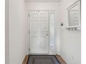 Simple entryway with white door and small rug at 804 E Ashley Ave, Folly Beach, SC 29439
