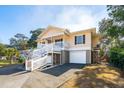 Two-story beach home with side entry, elevated deck, and double garage at 804 E Ashley Ave, Folly Beach, SC 29439