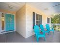 Front porch with three teal chairs and nautical decor at 804 E Ashley Ave, Folly Beach, SC 29439