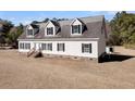 White house with gray roof and brick accents at 8978 Victor Lincoln Rd, McClellanville, SC 29458
