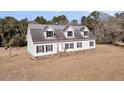 House exterior showcasing a spacious yard at 8978 Victor Lincoln Rd, McClellanville, SC 29458