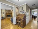 Hardwood floor hallway with a roll top desk and views into other rooms at 1001 Shinnecock Hills Ct, Summerville, SC 29483