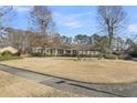 Well-maintained home with a spacious front yard, brick accents, and mature trees creating a peaceful setting at 101 Winston Cir, Summerville, SC 29485