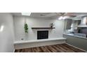 Inviting living room featuring a fireplace, hardwood floors, and modern kitchen at 102 Barrington Blvd, Goose Creek, SC 29445