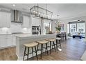 Bright kitchen with stainless steel appliances, modern lighting, and a large island with seating at 108 Crosscut Ln, Summerville, SC 29486