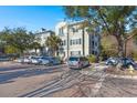 Building exterior with parking spaces and large trees at 1632 Telfair Way, Charleston, SC 29412
