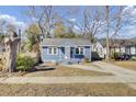Cozy blue home with a well-kept front yard and a classic design aesthetic at 1904 Iris St, North Charleston, SC 29405