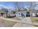 Quaint blue home featuring a welcoming front yard with a classic design at 1904 Iris St, North Charleston, SC 29405