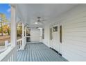 Inviting covered porch featuring white railing and a ceiling fan at 213 Rose Ave, Walterboro, SC 29488