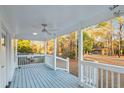 Inviting covered porch featuring white railing and a ceiling fan at 213 Rose Ave, Walterboro, SC 29488