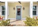 Charming front door with wreath and sidelights, welcoming porch at 2725 Battery Pringle Dr, Johns Island, SC 29455