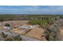 Expansive property featuring a home, outbuildings, and surrounded by lush forest at 2830 Wire Rd, Saint George, SC 29477