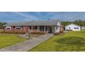 Well-maintained brick house with a spacious yard and a detached garage at 2830 Wire Rd, Saint George, SC 29477