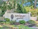 Community entrance sign for Sandpiper Pointe, surrounded by lush landscaping and mature trees at 313 Lapwing Ln, Mount Pleasant, SC 29464