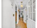 Inviting hallway featuring hardwood floors, neutral walls, and a well-lit entry to the home at 313 Lapwing Ln, Mount Pleasant, SC 29464