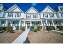 Charming townhome with a well-manicured lawn, inviting entrance, and classic architectural details at 393 Flyway Rd, Goose Creek, SC 29445