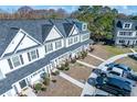 Aerial view of townhomes showcasing neat landscaping, private entrances, and resident parking at 393 Flyway Rd, Goose Creek, SC 29445