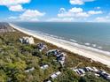 Wide aerial showcasing the community's beachfront location and proximity to the ocean at 4416 Sea Forest Dr, Kiawah Island, SC 29455
