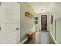 Bright entryway with green walls, wood bench, and coat rack at 5135 Park Creek Avenue, North Charleston, SC 29418