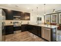 Modern kitchen with dark cabinetry, quartz countertops, and stainless steel appliances at 5135 Park Creek Avenue, North Charleston, SC 29418